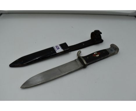 A German Third Reich Hitler Youth Dagger having black chequered grip with enamelled swastika emblem, blade marked RZM M7/13, 