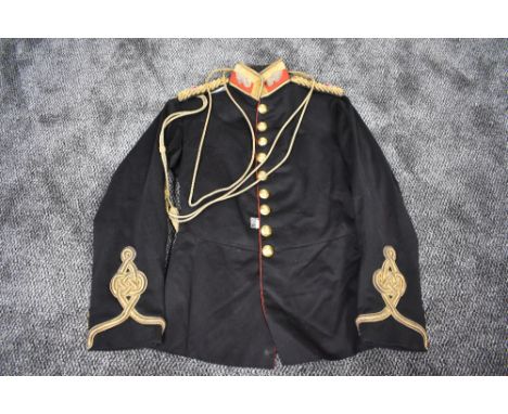 A Victorian British Royal Artillery Captains Dress Tunic in black with red trim having gold decoration, epaulettes, buttons a