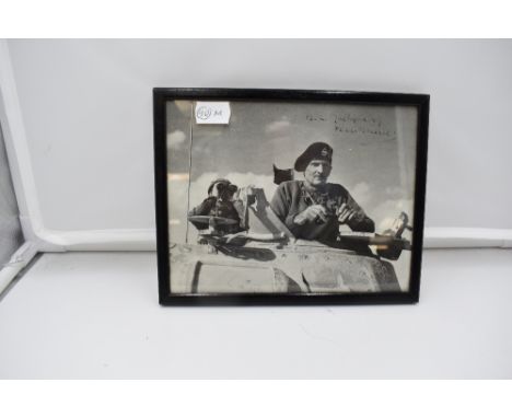 A 1940's framed photograph, Field Marshall, the Viscount Montgomery of Alamein in a Turret of a Tank bearing signature but fa