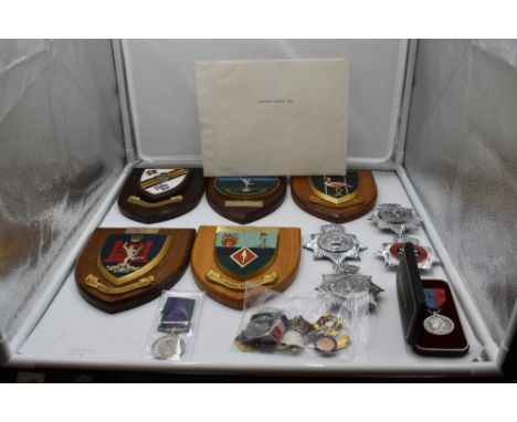 A collection of five Regiment Shields and four Police Cap Badges including South Wales, Birmingham, Denbighshire. A Queen Eli