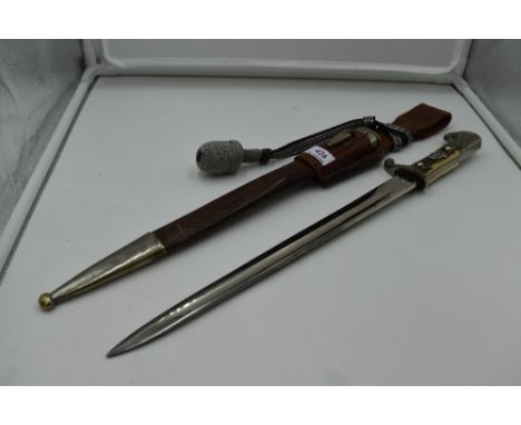 A German Third Reich Police Dagger, brown leather and metal scabbard, silver portepee knot, single edged blade, knights head 