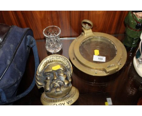 A VINTAGE BRASS PORT HOLE, TOGETHER WITH A BRASS HENRY VIII SHAPED DOOR KNOCKER 