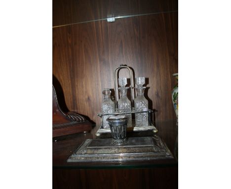 A SILVER PLATED DESK STAND & SIX BOTTLE CRUET
