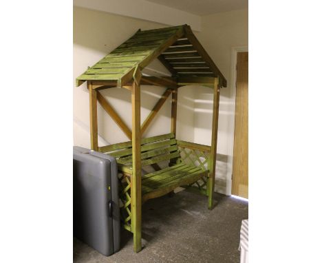 A WOODEN GARDEN BENCH WITH CANOPY