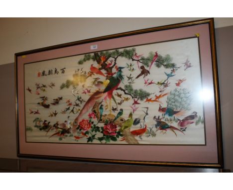 AN ORIENTAL SILKWORK PANEL DEPICTNG BIRDS - FRAMED & GLAZED