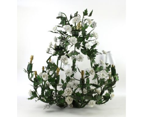 A metal twelve branch chandelier, with white rose design, H.81cm       Needs to be re-wired.Only 7 white covers present. Some