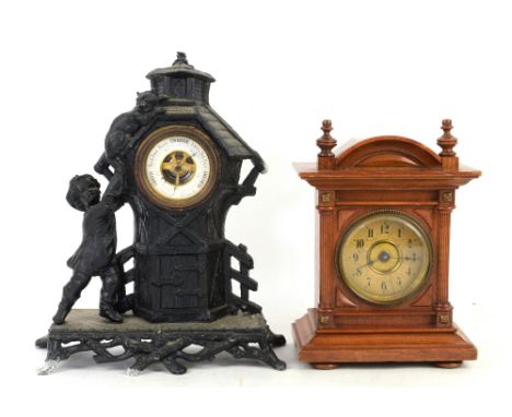 Cast metal table top aneroid barometer, the case of architectural form with young child and cat to roof, H.29cm, together wit