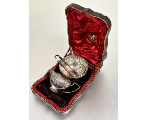 A Epns milk jug and sugar basin, a sugar sifter and a Birmingham silver pair of sugar tongs in associated fitted case (Alot)