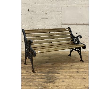 A cast metal and slatted teak three seat garden bench. L126cm.&nbsp;