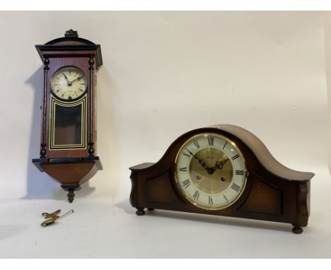 A walnut cased dome top mantel clock by Hermle, with cream dial and Roman chapter ring, the eight day twin train movement str