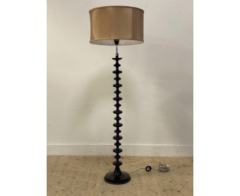 A contemporary lamp standard, the column, of bobbin form, raised on a circular base, complete with shade. H164cm.&nbsp;