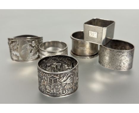 A collection of napkin rings to include a Birmingham silver with engine turned decoration and cast border, a Birmingham silve