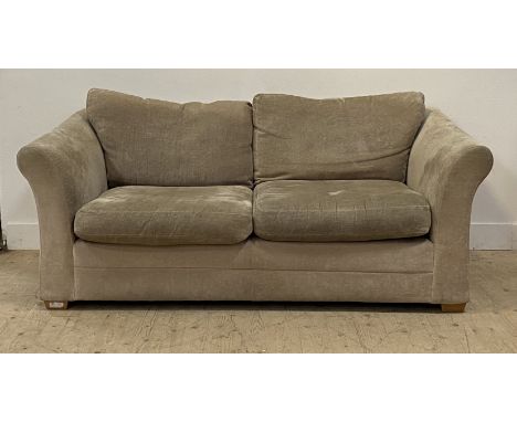 A contemporary fawn plush two seat sofa, with squab cushions and raised on block supports. H80cm, W190cm, D100cm.&nbsp;