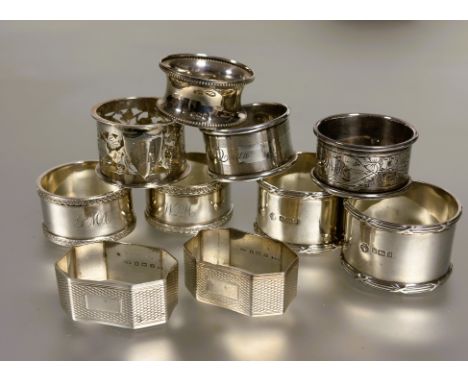 A collection of silver napkin rings to include a pair of Sheffield silver reeded bordered design napkin rings H x 3cm, a pair