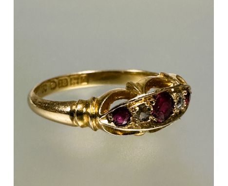 A 18ct gold three stony ruby ring the center cut stone 0.15ct flanked by a rose cut diamond and circular cut ruby within a sw