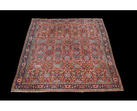 A Ziegler-Mahal carpet, the madder field decorated with an overall design of flowerheads and meandering vines in tones of blu