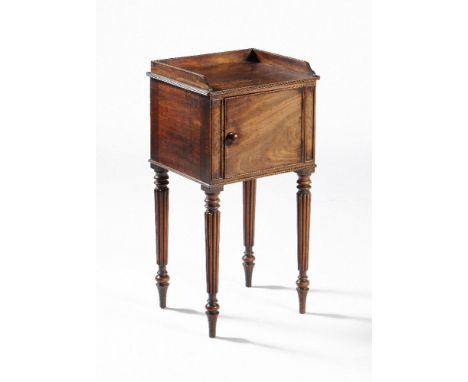 A Regency mahogany bedside cabinet, almost certainly by Gillows, circa 1815, the rectangular top with three quarter reeded ga