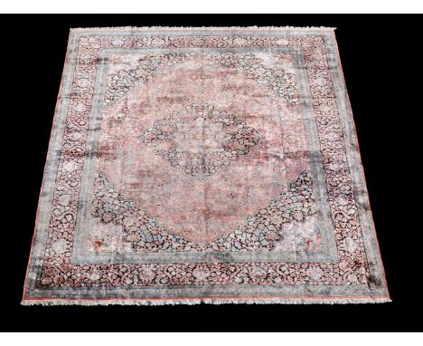 A Tabriz silk carpet, finely decorated throughout with floral branches and foliage, with the pastel pink field centred by a n