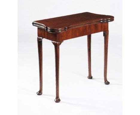 A George II mahogany concertina action folding card table, circa 1740, the rectangular top opening to baize inset playing sur