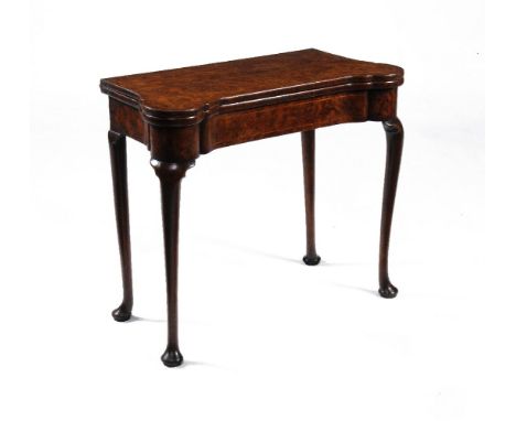 A George II burr walnut and feather banded folding card table, circa 1735, the quarter veneered and crossbanded top with outs