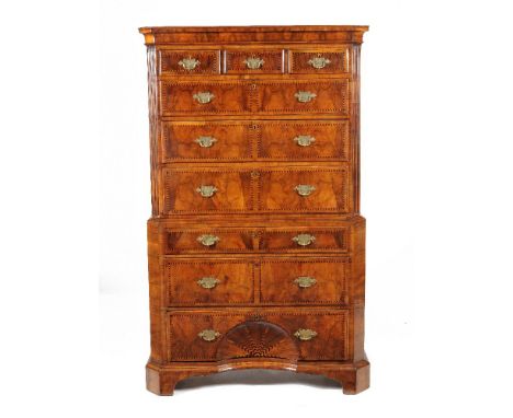A George II figured walnut chest on chest, circa 1735, each drawer decorated with chevron banding, the moulded cornice above 