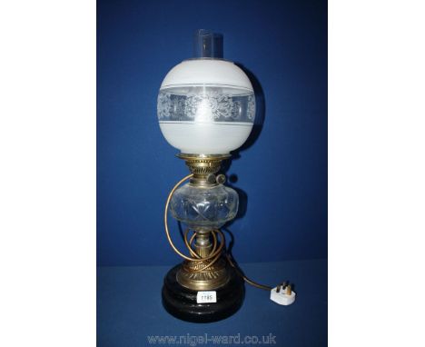 An Oil Lamp converted to electric with clear cut glass reservoir and etched globe shade.