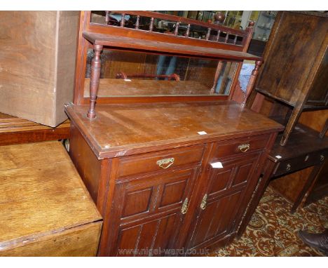 An Edwardian Mahogany Sideboard of small proportions having a raised shelf with a mirror below and with turned spindle detail