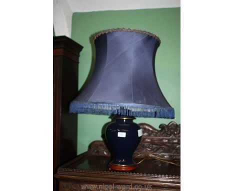 A Wade Table lamp and blue silk shade.