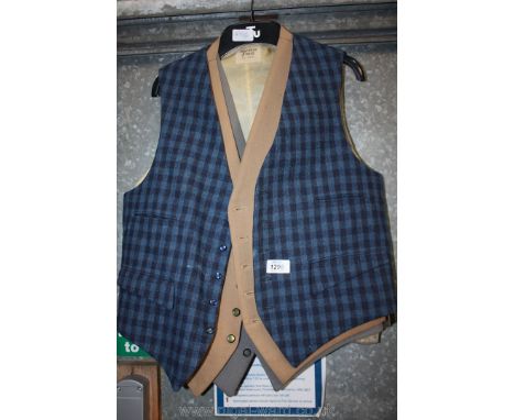 Three gentlemen's waistcoats including Doeskin finish, all wool, a two-toned blue check, camel and light grey colour.