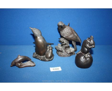 A bronze figure of a penguin with two chicks, signed Richard Fisher, a/f, a Bronzed Dolphin, signed, a mouse on an apple and 