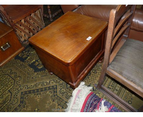 A late Victorian Mahogany Box Commode with hinged lid having fold down arms and standing on turned feet, furnished, 20'' wide