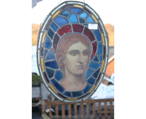 A leaded stained glass Panel, part of a larger window depicting the young Christ with a ruby glass halo, 16 1/4'' x 11 3/4'',