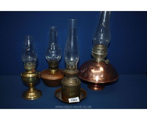 An unusual domed copper oil lamp and three smaller lamps.