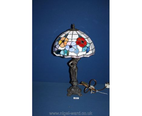 A Tiffany style Lamp, the metal base depicting a woman.
