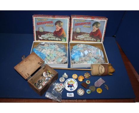 A Winnie the Pooh jack in the box puppet, a quantity of old badges and two Victory wooden puzzles, British Isles and England 