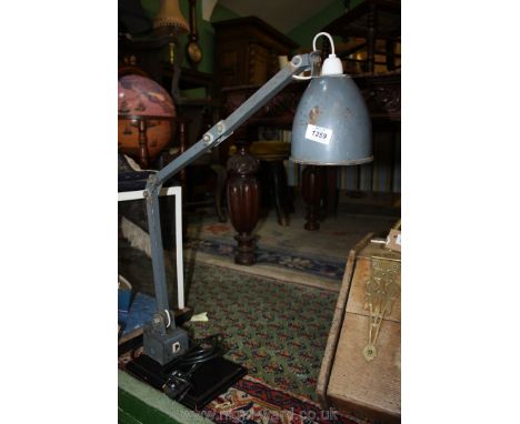 A Memlite industrial work lamp mounted on a wooden base.