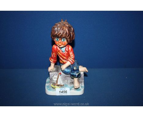 A large Goebel figure of a boy playing with his boat, 8" high, Michel T signature on back.