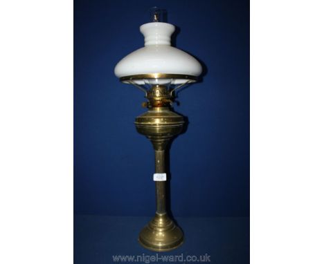 A tall Brass paraffin Lamp with half circular shade.