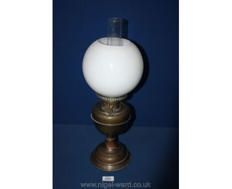 An oil Lamp with white glass globe shade.