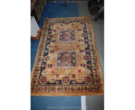 A light brown Rug with navy border and square pattern to the centre, 59" x 37".
