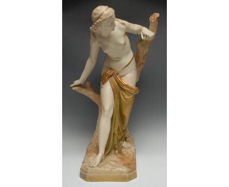 A Royal Worcester figure, modelled by Sir Thomas Brock, The Bather Surprised, she stands scantilly draped, by a tree stump,  