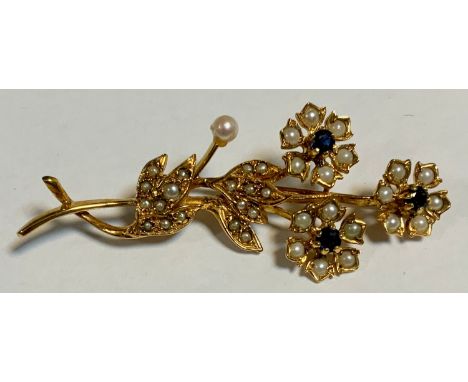 A mid 20th century seed pearl and deep blue sapphire floral spray brooch, sinuous triple flower head body encrusted with mixe