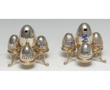 A pair of Victorian silver and enamel trefoil cruets, each with an arrangement of egg shaped condiments, crested and labelled