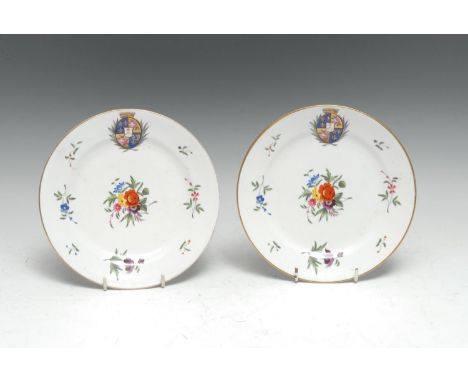 A pair of Chamberlain's Worcester armorial circular dessert plates, painted with a noble coat of arms quartering fleur-de-lys