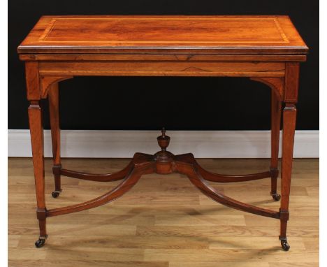 An Edwardian rosewood rectangular card table, hinged satinwood banded top enclosing a baize lined playing surface with tooled