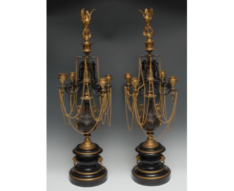 A pair of gilt metal, bronzed and slate five light four branch candleabra, bird finials, scroll arms, baluster columns, shape