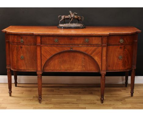 A Regency mahogany sideboard, slightly oversailing crossbanded top above three frieze drawers, an apron drawer, a cupboard do