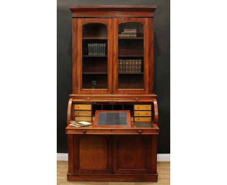 A Victorian mahogany cylinder bureau bookcase, moulded cornice above a pair of glazed doors enclosing three adjustable shelve