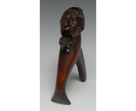 A Black Forest novelty lever-action nut cracker, carved as a gentleman wearing a night cap, 18cm long 