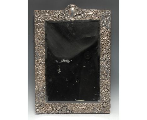 A large Victorian silver rectangular easel dressing table mirror, pierced and profusely embossed with birds, flowers and scro